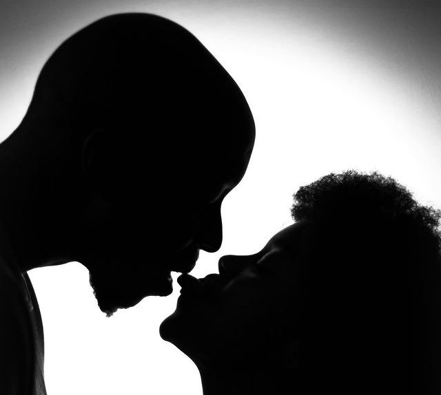 Photo of Edith with a guy giving her tongue.